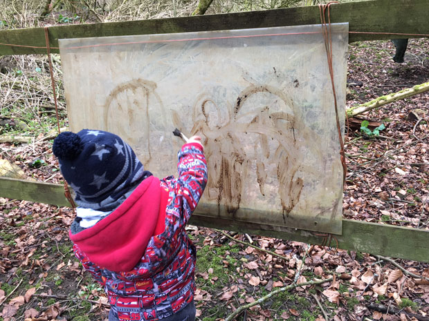 Mud painting at Forest School at Rendcomb College