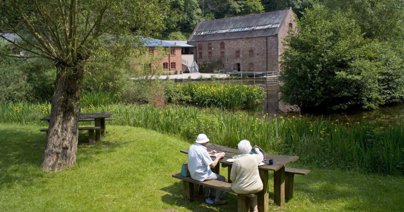 Elderly couple having a picnic by the Mill Pond at Dean Heritage Centre