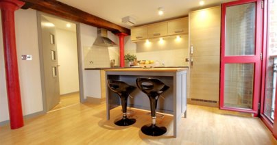 The modern kitchen has integrated appliances, including a fridge, freezer and oven.